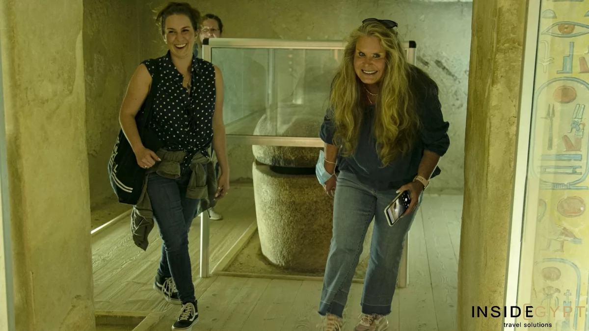 Two tourists inside a Valley of the Queens tomb in Luxor 
