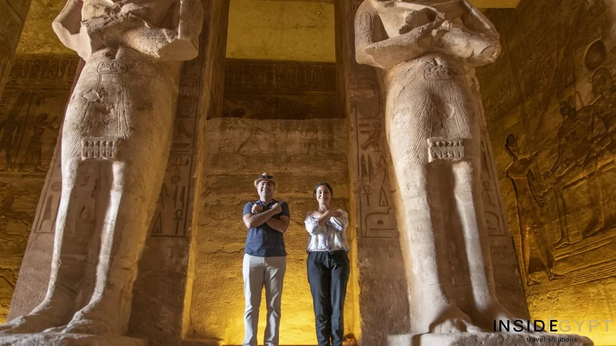 Two tourists posing for a picture inside the Temple of Ramesses II the Great 