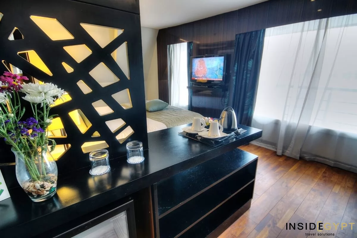 Nile cruise double bed room with a TV set