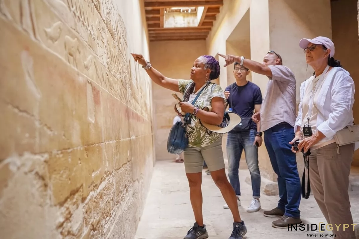 Tourists admiring the hieroglyphs in tomb of the Kagemni in Saqqara 