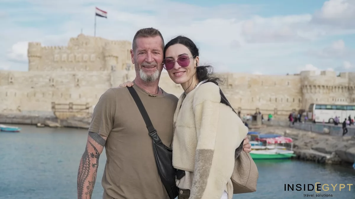 Tourists posing for a picture in front of the Citadel of Qaitbay in Alexandria 
