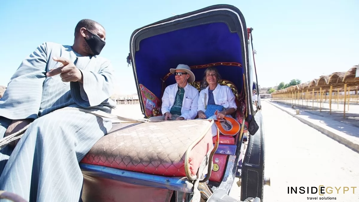 Two tourists in a Rickshaw driven by an Egyptian guide